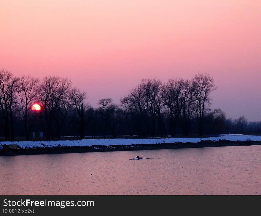 Man rowing at cold evening. Man rowing at cold evening.