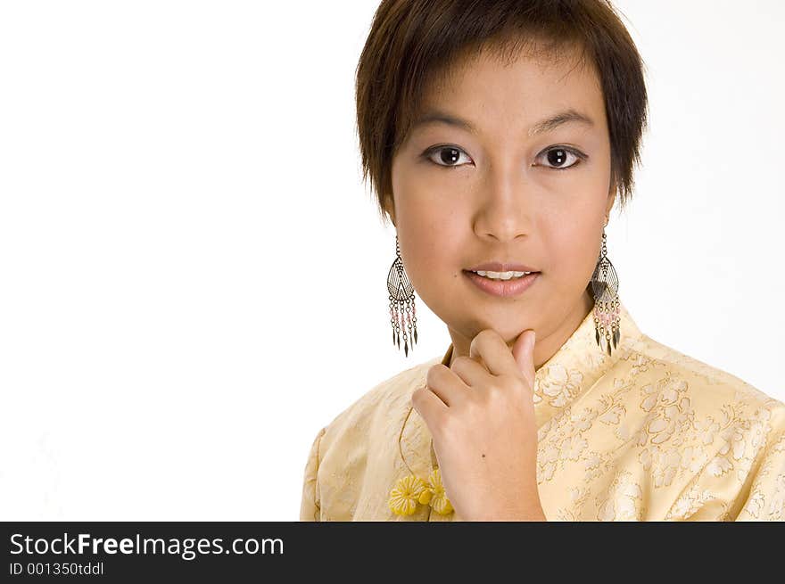 An attractive young asian woman in a yellow silk jacket. An attractive young asian woman in a yellow silk jacket