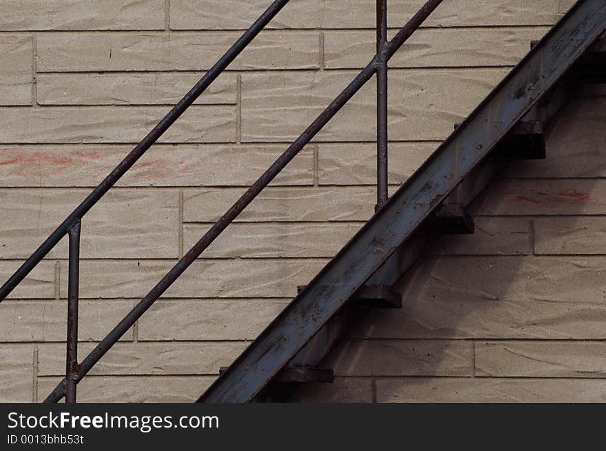 Rusty black fire escape against the brick wall of a residential building