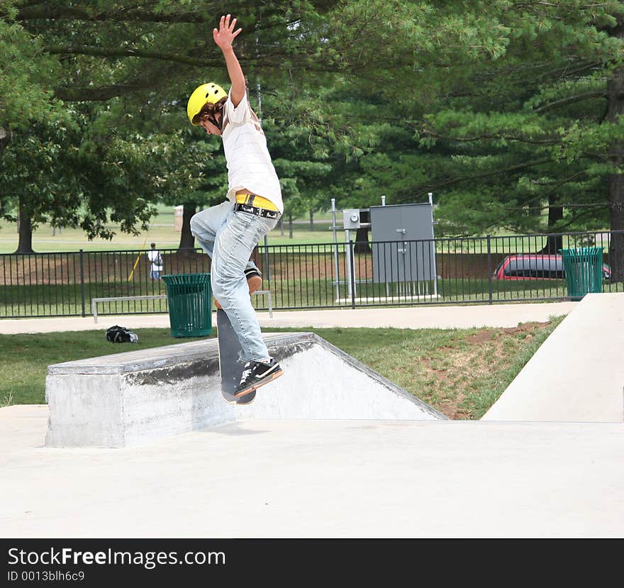 Teen male skateboarder jumping onto a wall at a skate park. Shot with Canon 20D. Teen male skateboarder jumping onto a wall at a skate park. Shot with Canon 20D.