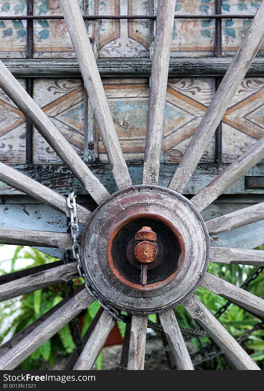 Old, antique wooden cartwheel with bolt and chain. Old, antique wooden cartwheel with bolt and chain