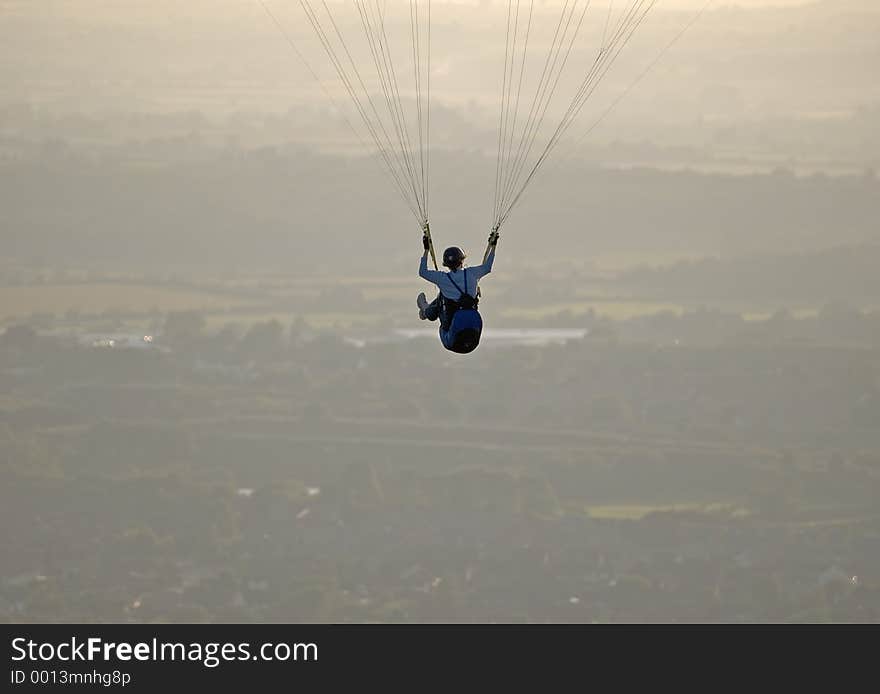 Paraglider fying high over the English countryside. Paraglider fying high over the English countryside