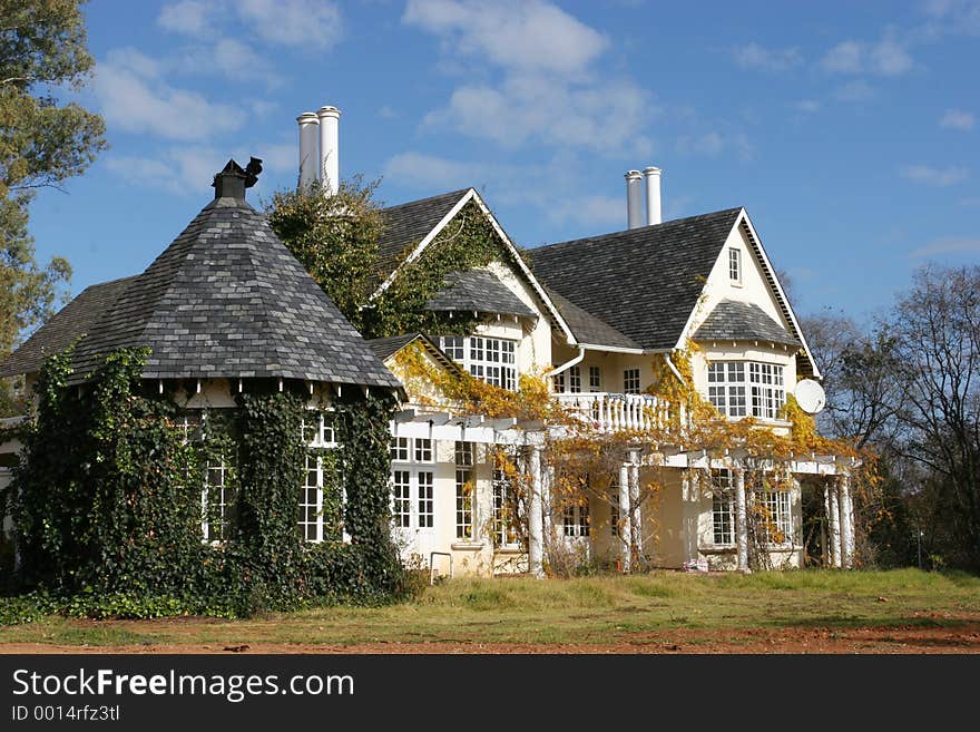 Country style house grown over by plants