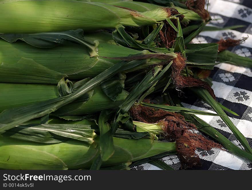 Corn sitting on a picnic table. Corn sitting on a picnic table.