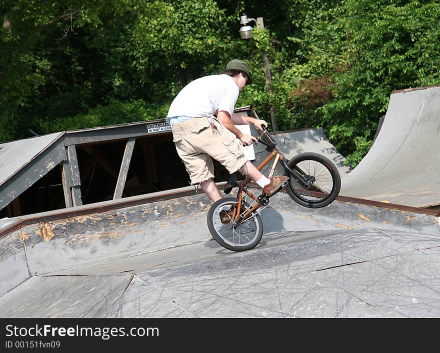 BMX biker doing tricks at skate park. Shot with a Canon 20D. BMX biker doing tricks at skate park. Shot with a Canon 20D.