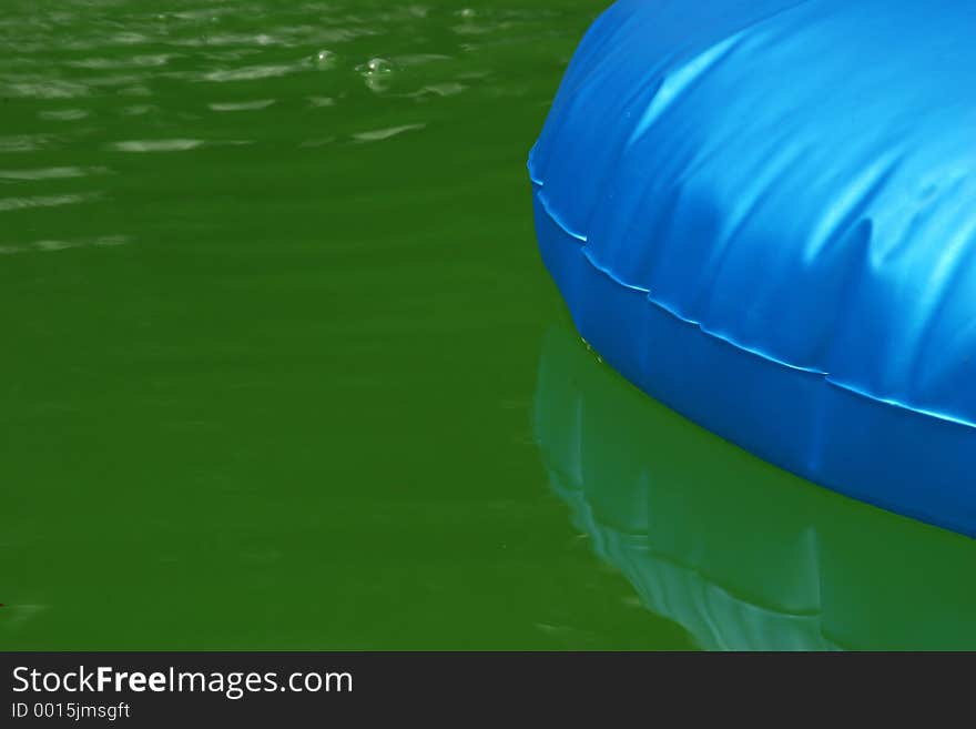 A blue float in a green pool. A blue float in a green pool.