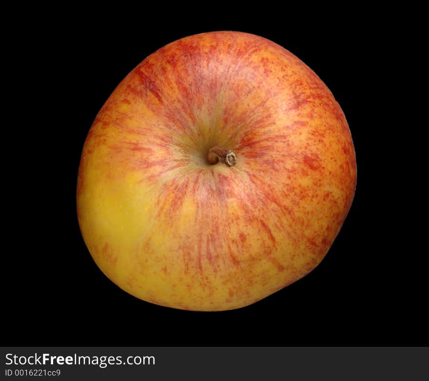 A red and yellow apple isolated over black, top down view. A red and yellow apple isolated over black, top down view.