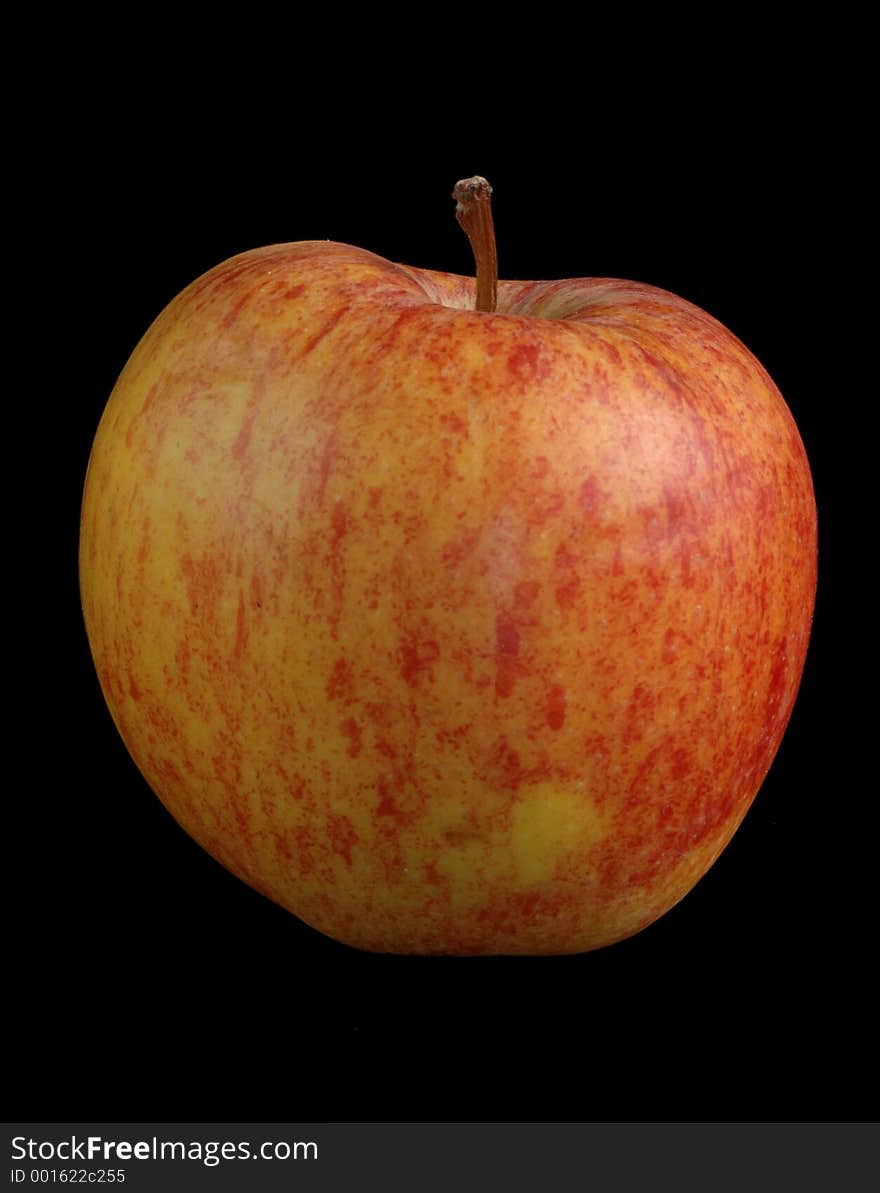 A red and yellow apple over black