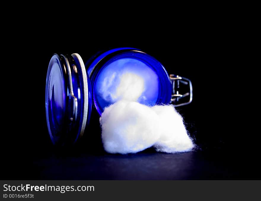 Cotton Balls spilling out of a jar.