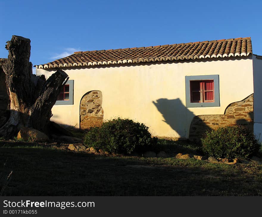 Traditional rural house of the south of Portugal. The colors are typical, with white walls (to minimize the heat of the sun) and blue frames. Traditional rural house of the south of Portugal. The colors are typical, with white walls (to minimize the heat of the sun) and blue frames