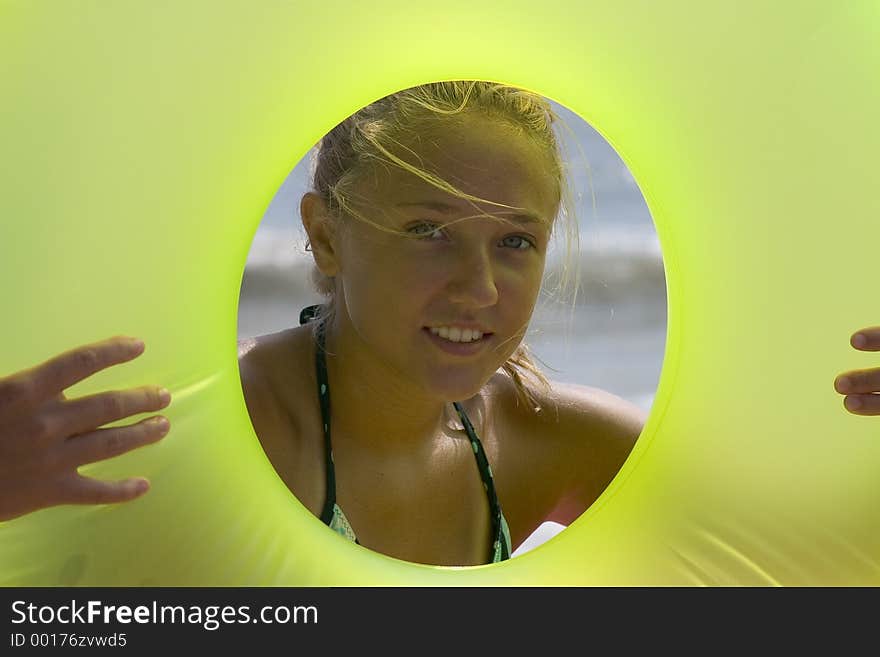 A pretty teenage girl prepares to play at the beach. A pretty teenage girl prepares to play at the beach.