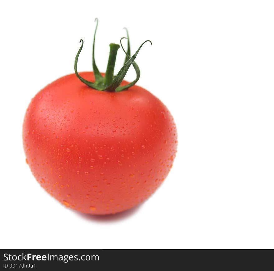 Isolated tomato with water droplets on it - pure white background with small shadow. Isolated tomato with water droplets on it - pure white background with small shadow