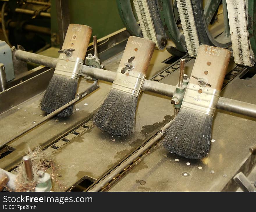 Brushes on vintage stitcher in publishing house. Brushes on vintage stitcher in publishing house