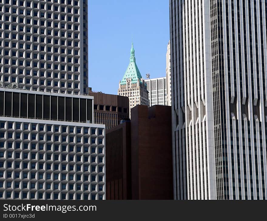 Smaller building between two skyscrapers in lower Manhattan, New York City, USA