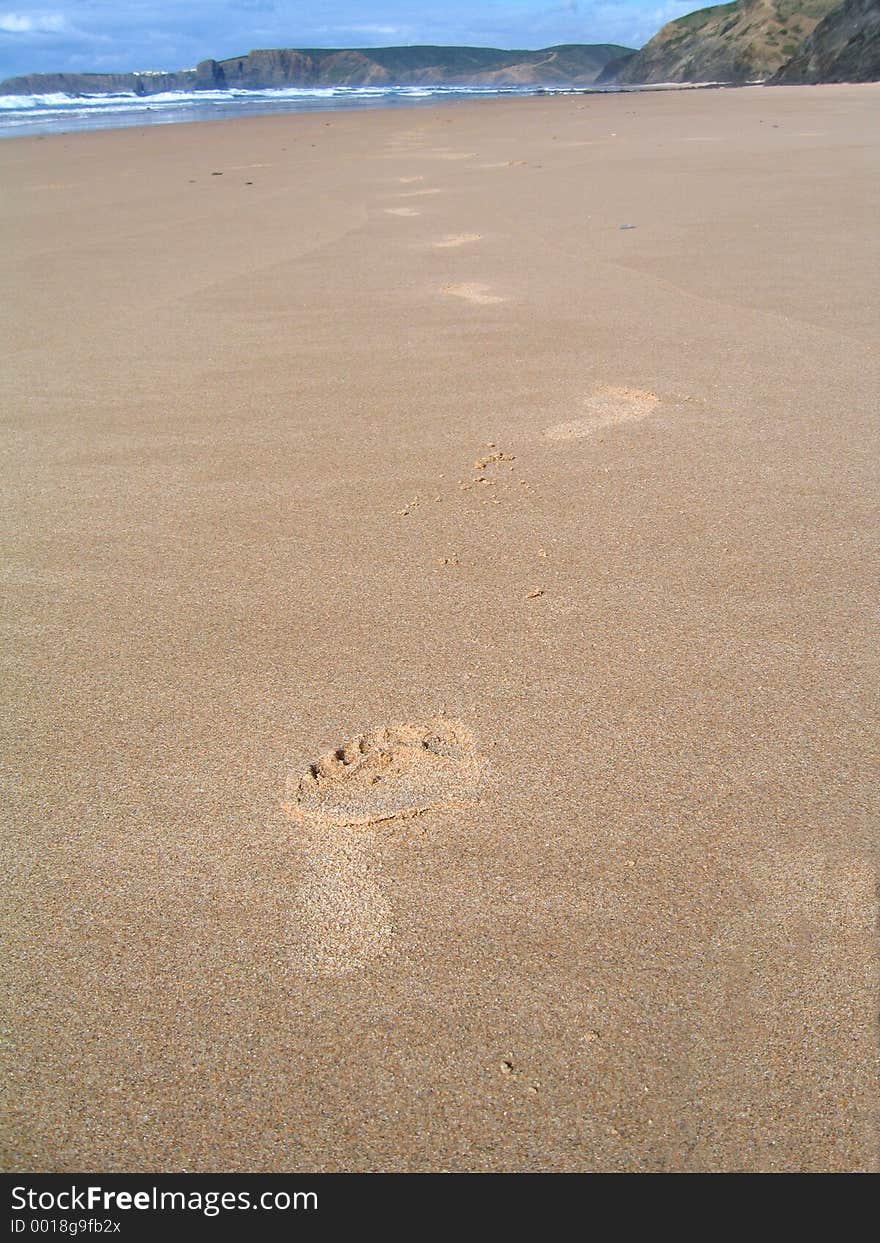 Footprints in an empty beach in the west coast of Portugal. Footprints in an empty beach in the west coast of Portugal