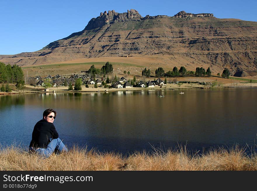 Woman looking at landscape of mountain and holiday lodge. Woman looking at landscape of mountain and holiday lodge
