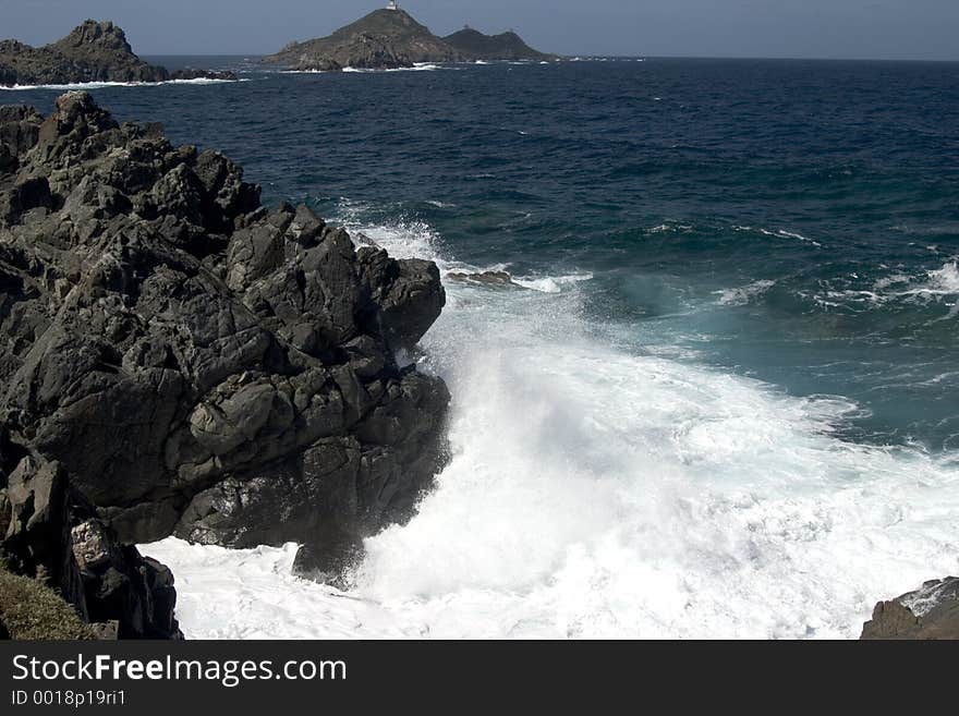 The ocean crashing on the shore against the rock. The ocean crashing on the shore against the rock