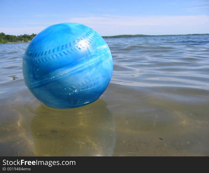 Blue ball floating in lake. Blue ball floating in lake