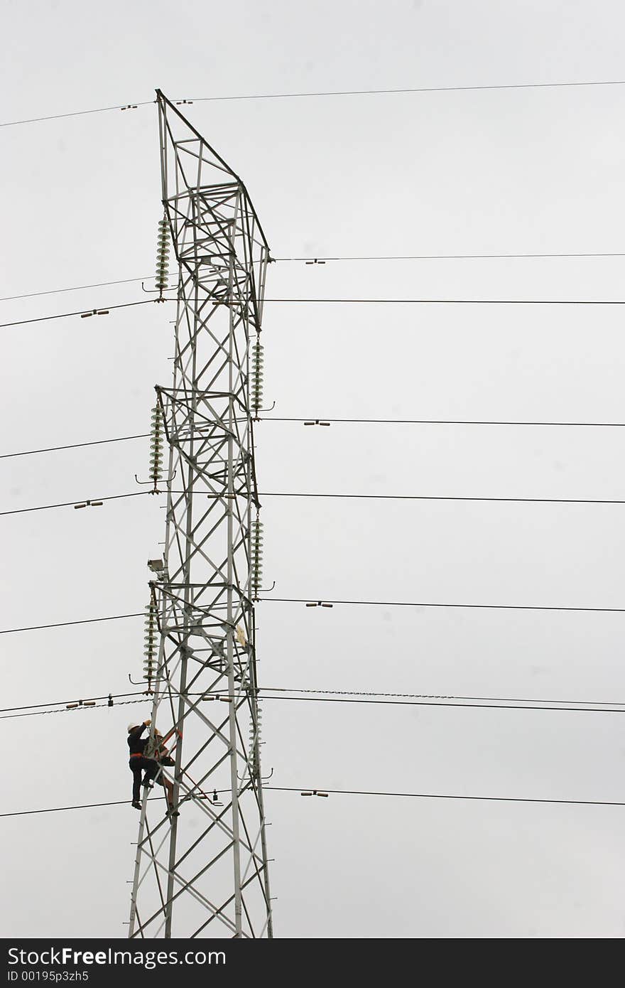 Workers climbing on power pylon