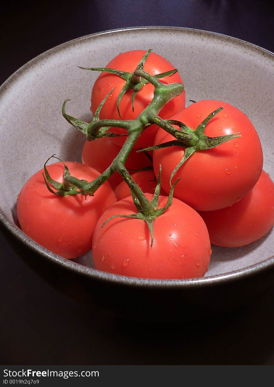 Bowl of red tomatoes on vine. Bowl of red tomatoes on vine