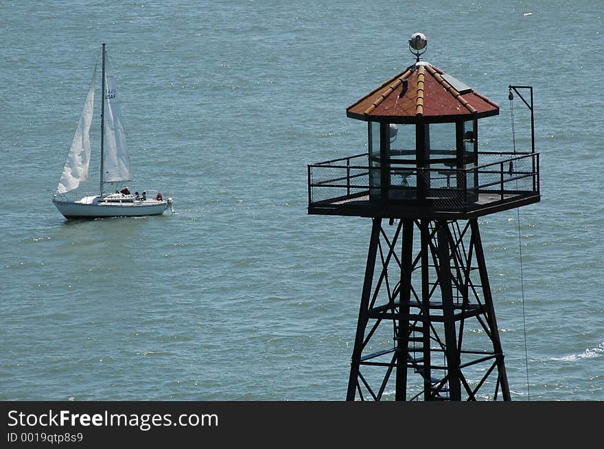 Tower and sailboat in ocean