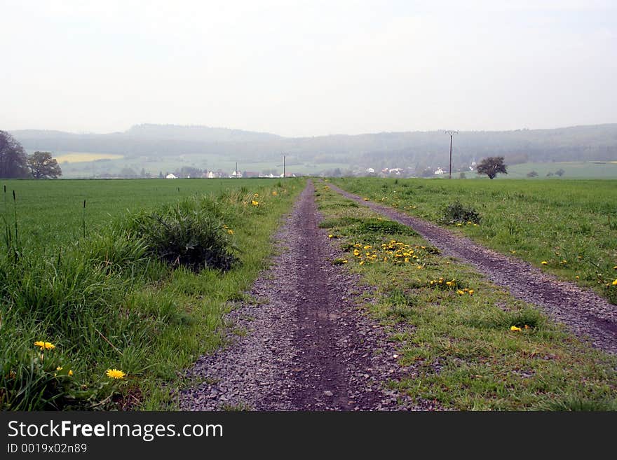 A small country-side road heading to town. A small country-side road heading to town