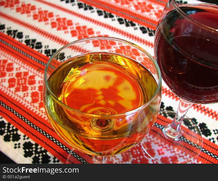 Wine glasses on a patterned table-cloth