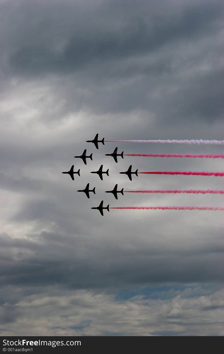 Beautiful flying formation by RAF Red Arrows in Eastbourne Air Show 2005. Taken against cloudy sky to add textures. Beautiful flying formation by RAF Red Arrows in Eastbourne Air Show 2005. Taken against cloudy sky to add textures.