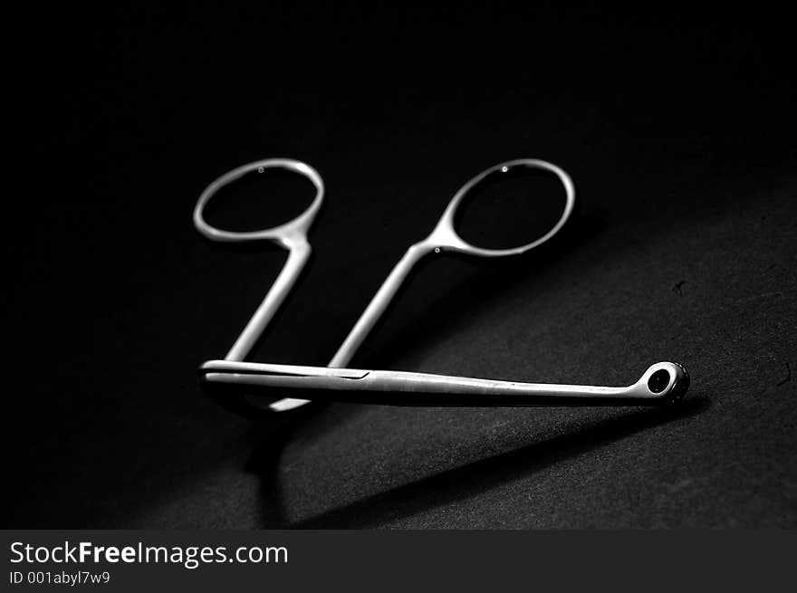 Angled Forcep clamp over black (limited depth of field, focused on tip and fading gently backward). Angled Forcep clamp over black (limited depth of field, focused on tip and fading gently backward)