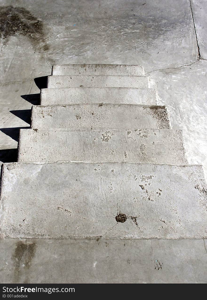 Looking down some concrete steps at a skate park. Has a gritty, urban texture. Looking down some concrete steps at a skate park. Has a gritty, urban texture.