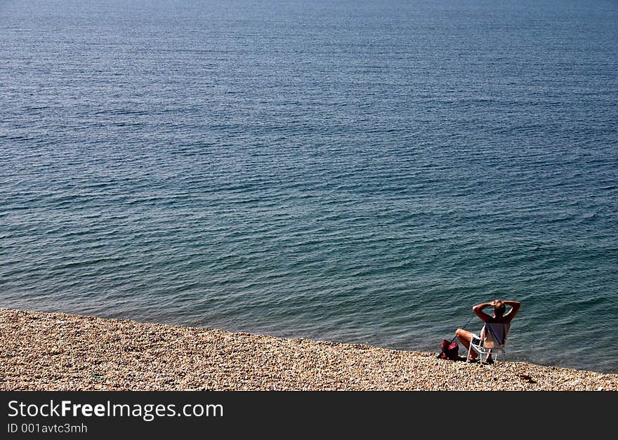 Man alone at the beach enjoying the peace & quiet. Man alone at the beach enjoying the peace & quiet