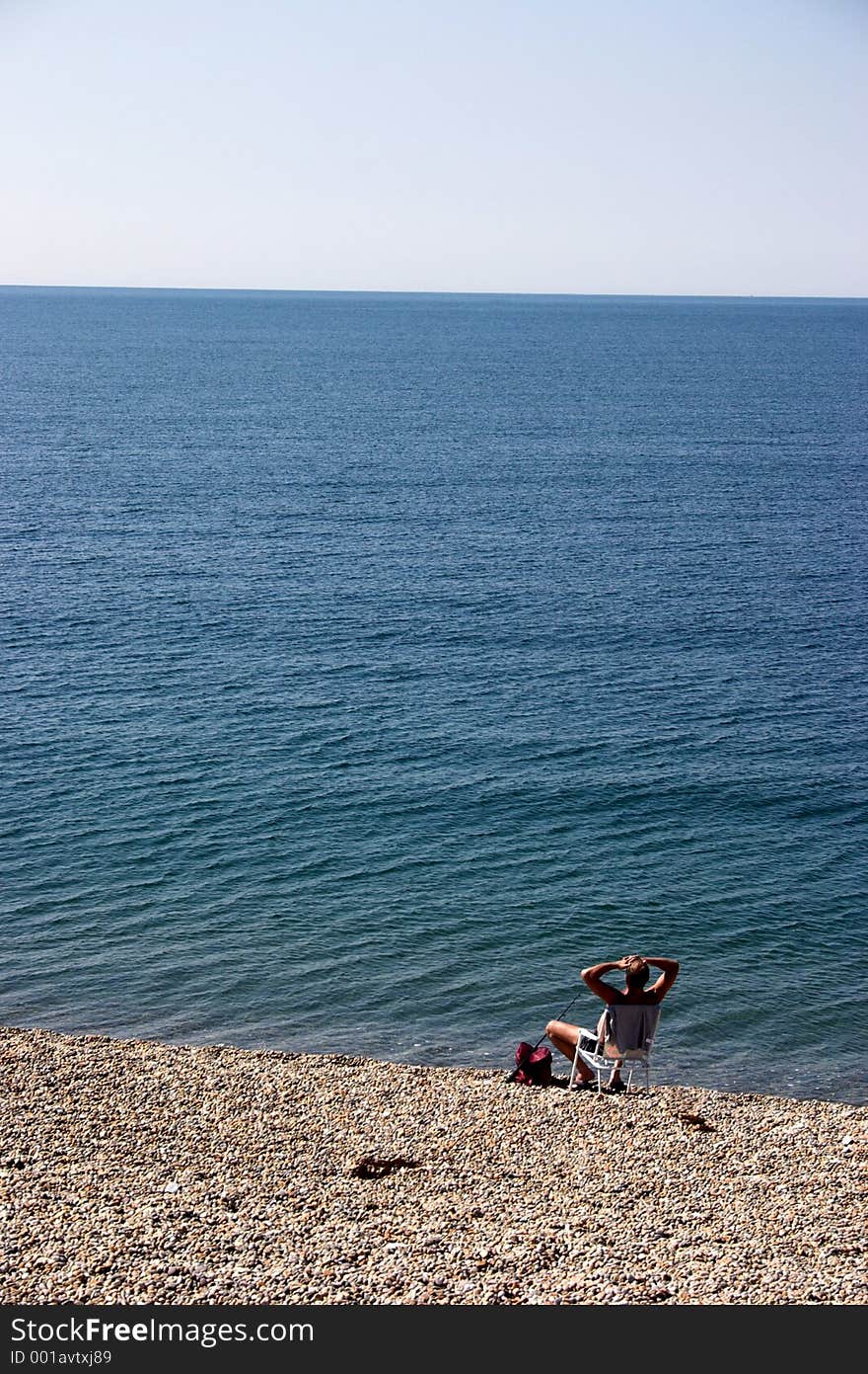 Man at the beach, fishing & relaxing. Man at the beach, fishing & relaxing