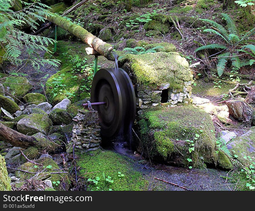 Moss-covered powerhouse and water wheel