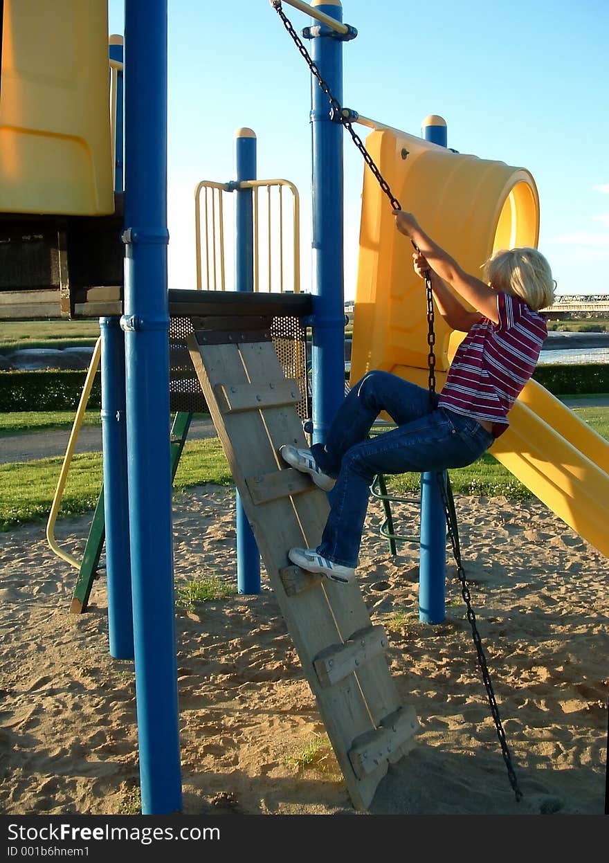 A young girl climbing on playground equipment. A young girl climbing on playground equipment
