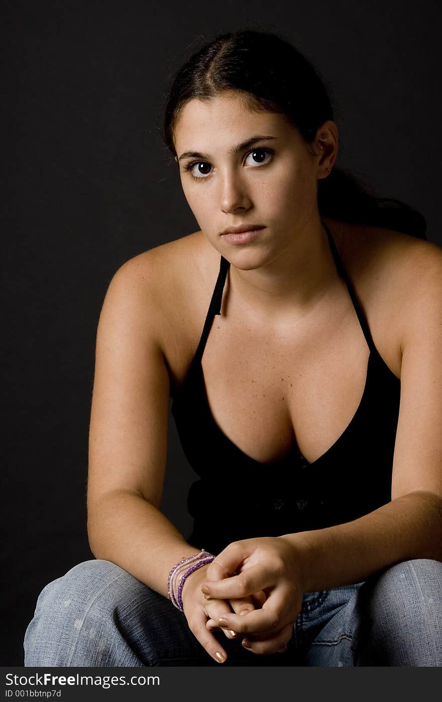 A naturally attractive woman in a black top and jeans. A naturally attractive woman in a black top and jeans