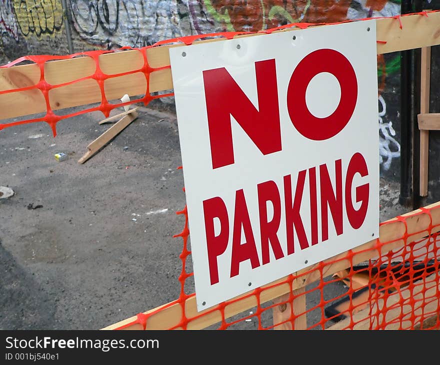 No Parking sign on a construction fence. No Parking sign on a construction fence