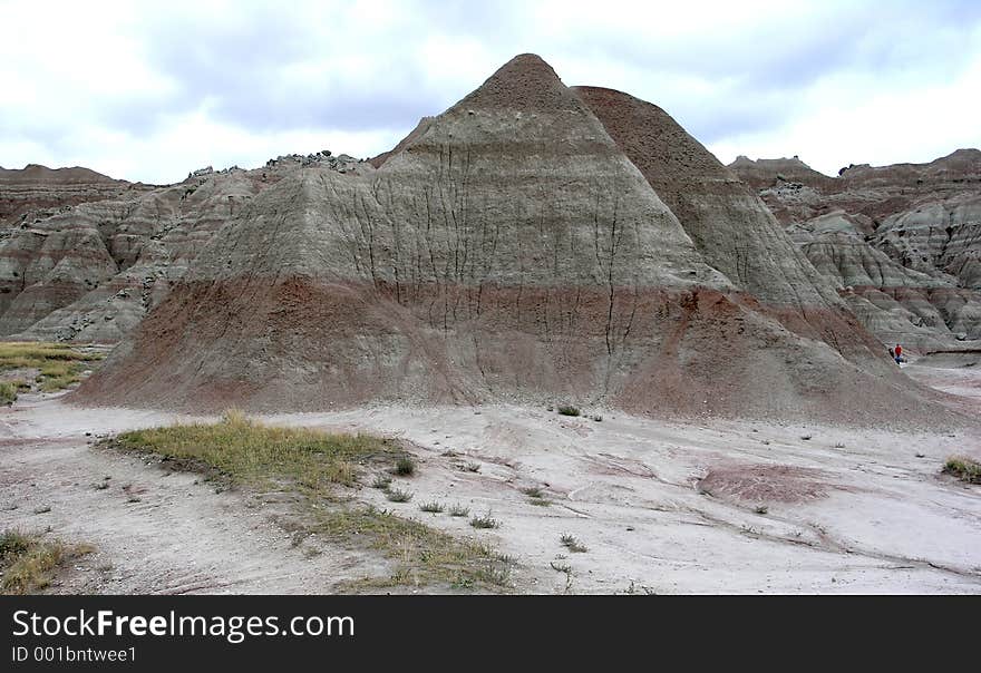 Red bands of color stripe the jagged rock formations of the South Dakota Badlands. Red bands of color stripe the jagged rock formations of the South Dakota Badlands.