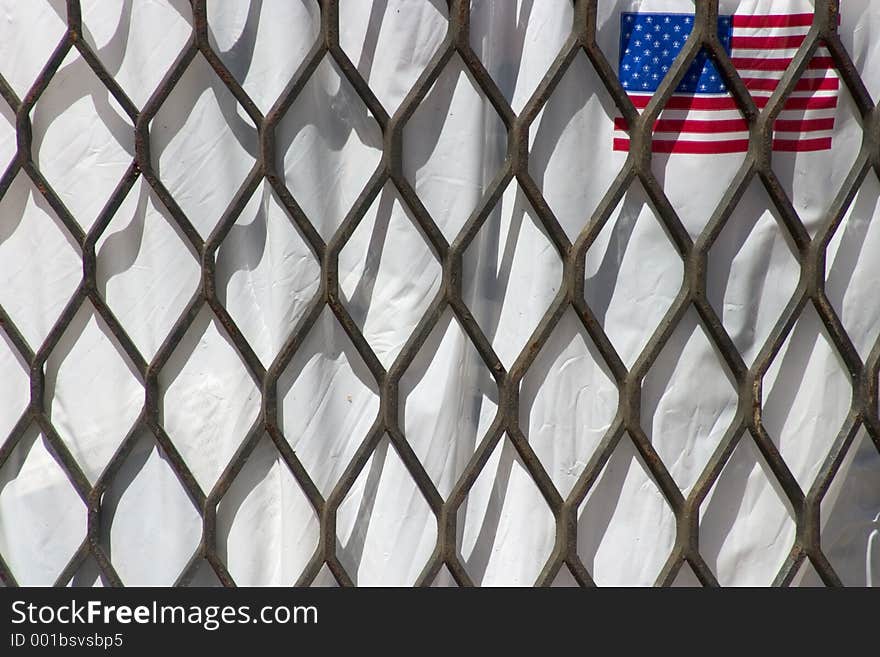 An American flag on a white trash bag inside a trash can. An American flag on a white trash bag inside a trash can