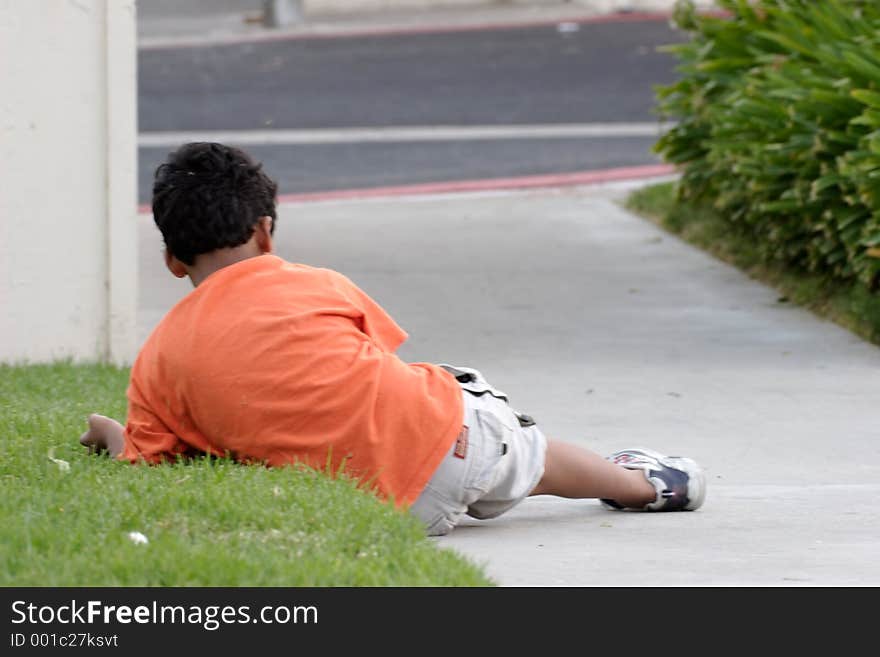 Boy laying on the grass resting