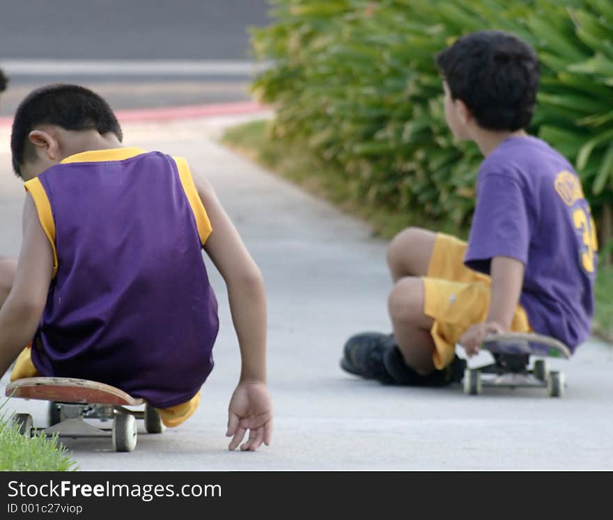 Two boys Taking a Break from skateboarding