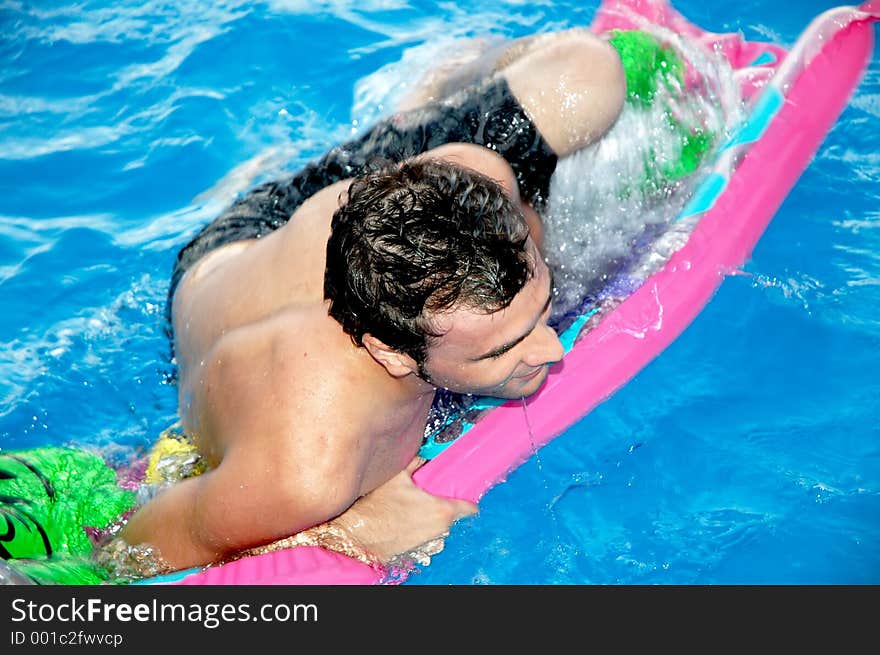 Handsome young man having fun in pool. Handsome young man having fun in pool