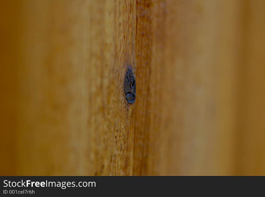 A very selective focused shot of knot in a section of wood.