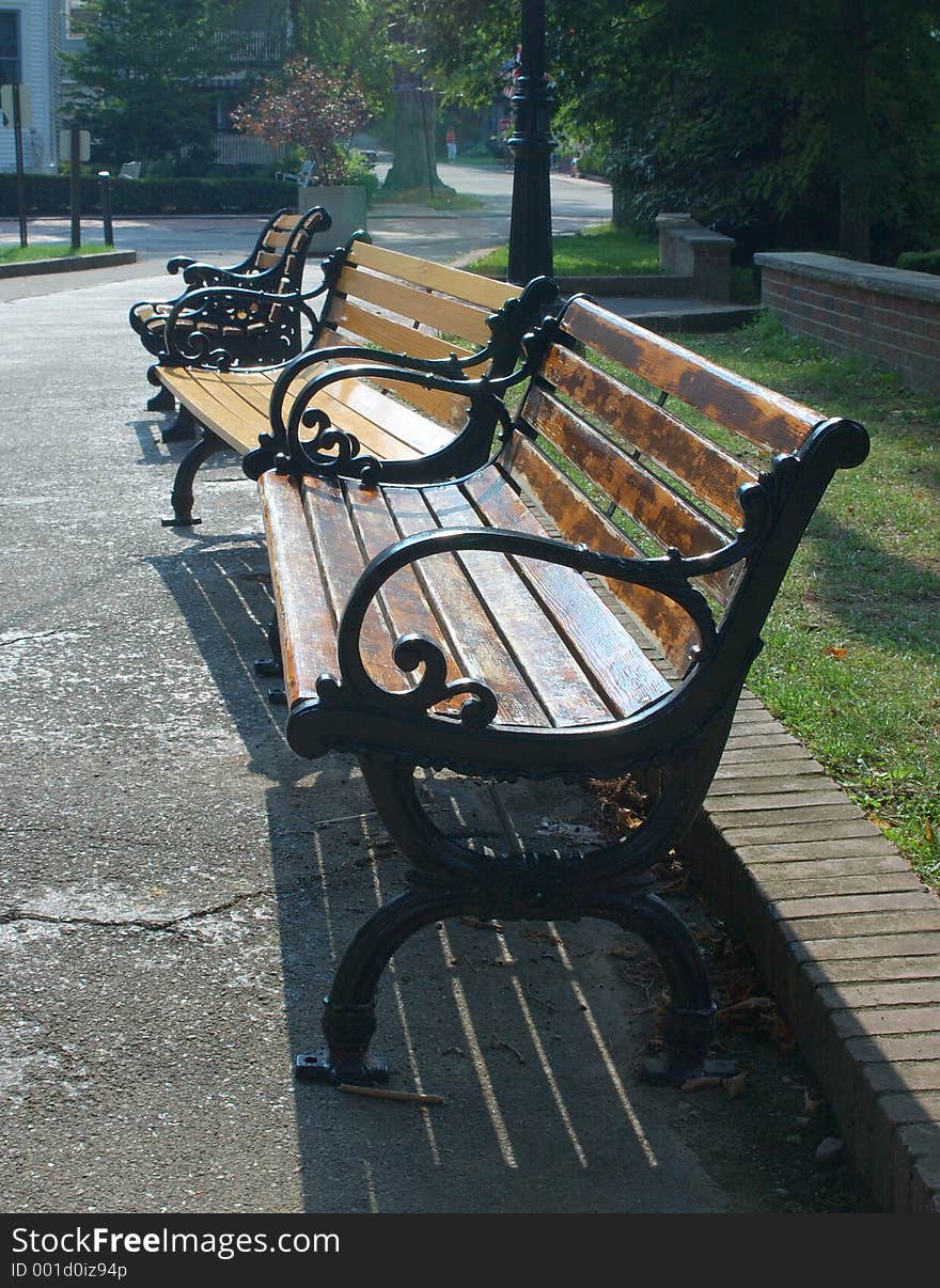 A trio of classic benches along a walkway