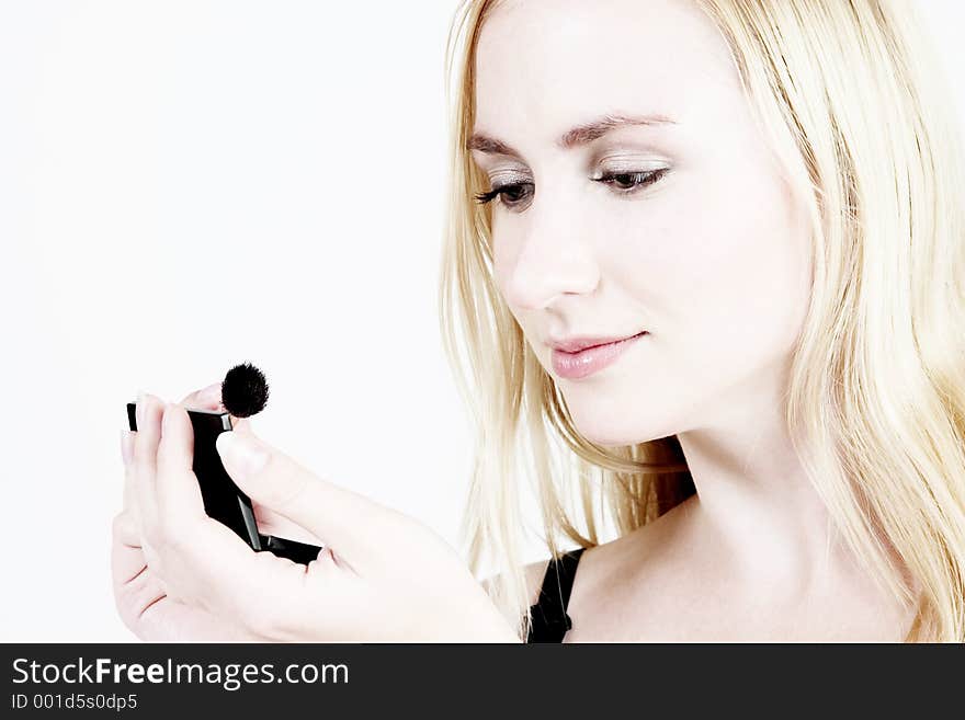 Young blond girl doing make-up. Young blond girl doing make-up