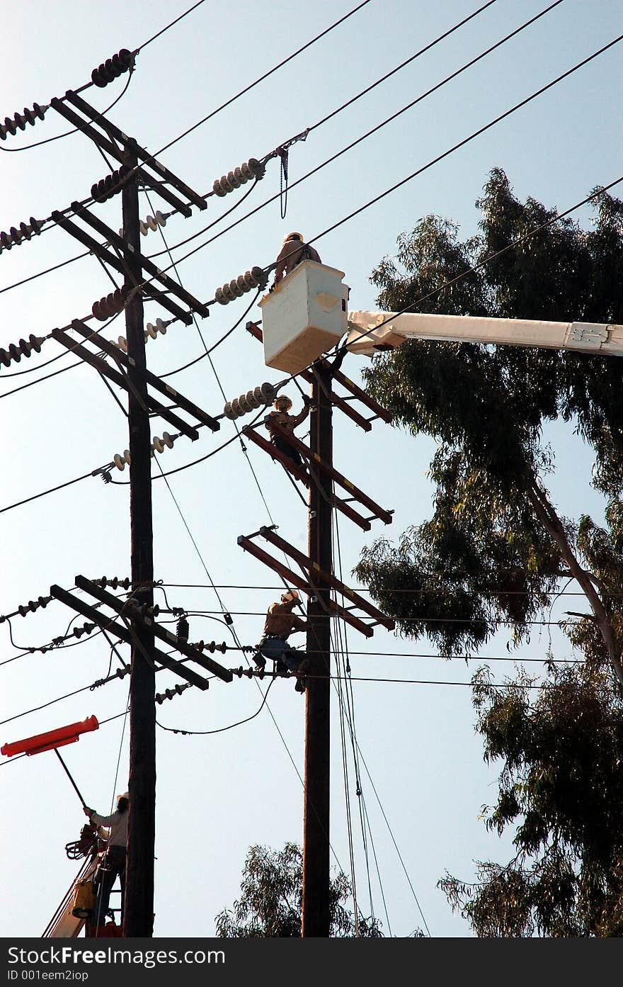 Men working on pole repairing and moving lines. Men working on pole repairing and moving lines