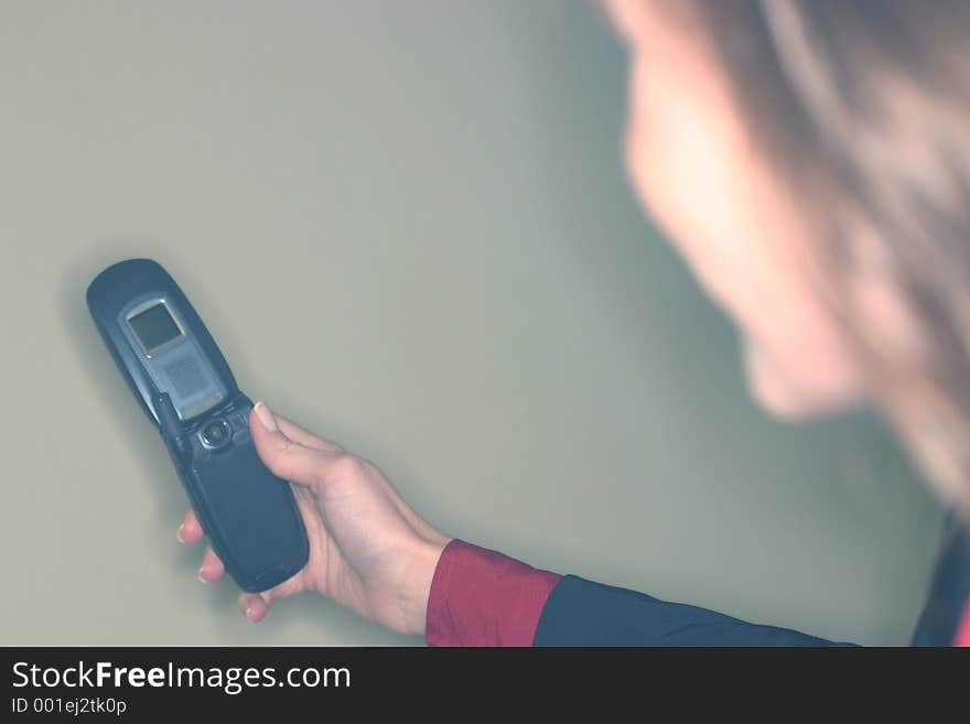 A young woman in a suit, takes a picture with a picture-phone. A young woman in a suit, takes a picture with a picture-phone.