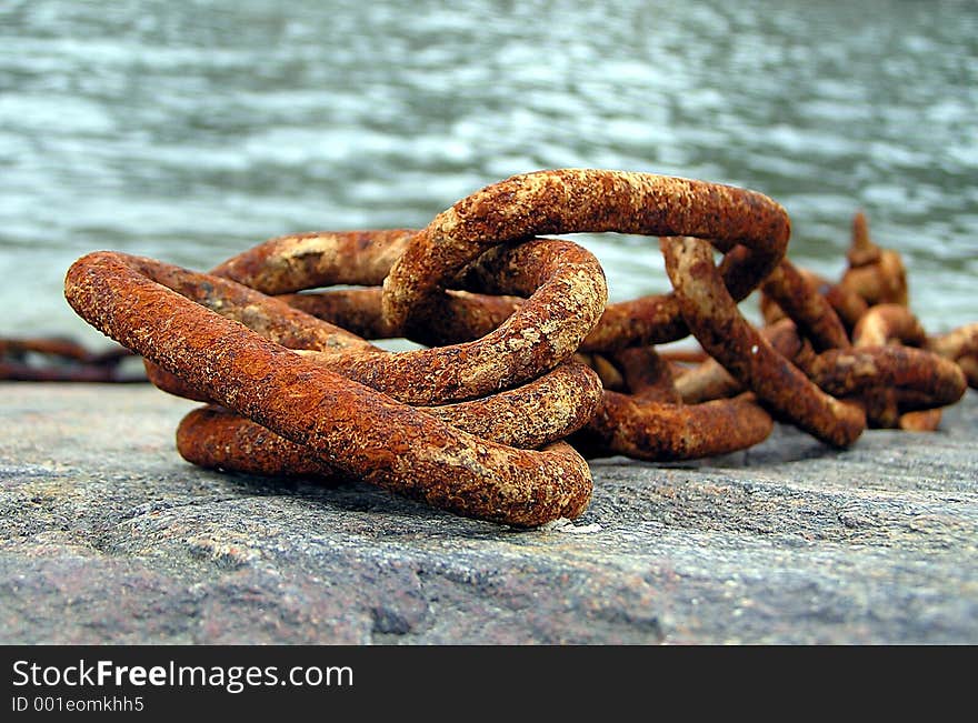 A rusty chain in the harbor