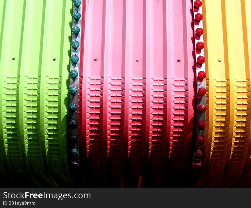 Details of the top of a fairground ride showing shape and colour. Details of the top of a fairground ride showing shape and colour