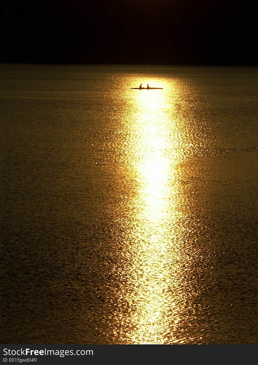 Two kayaker silhouettes against the sunset 0814_31. Two kayaker silhouettes against the sunset 0814_31