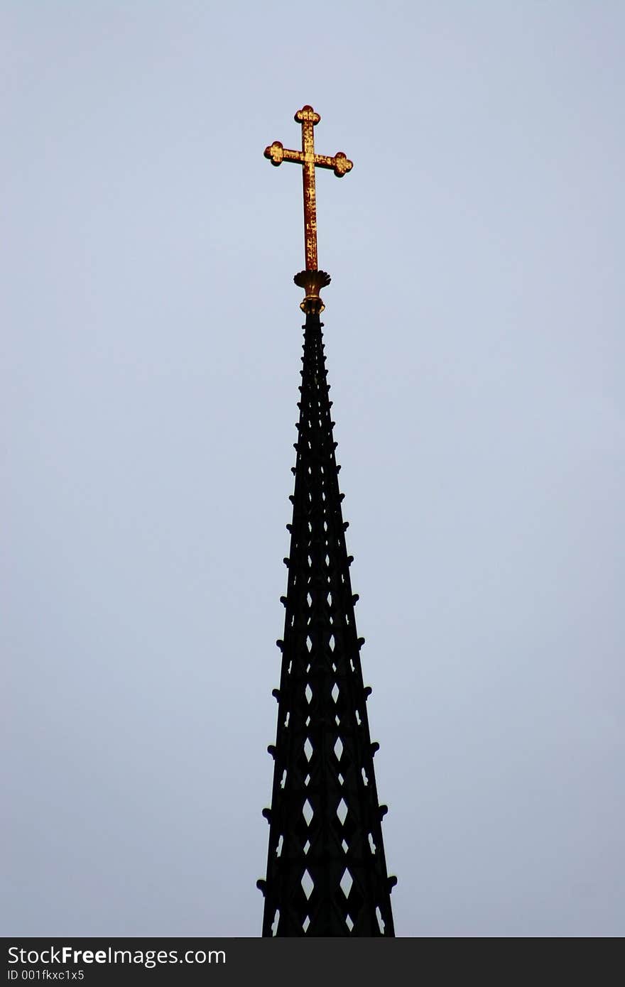 A Cross high up on a Church.